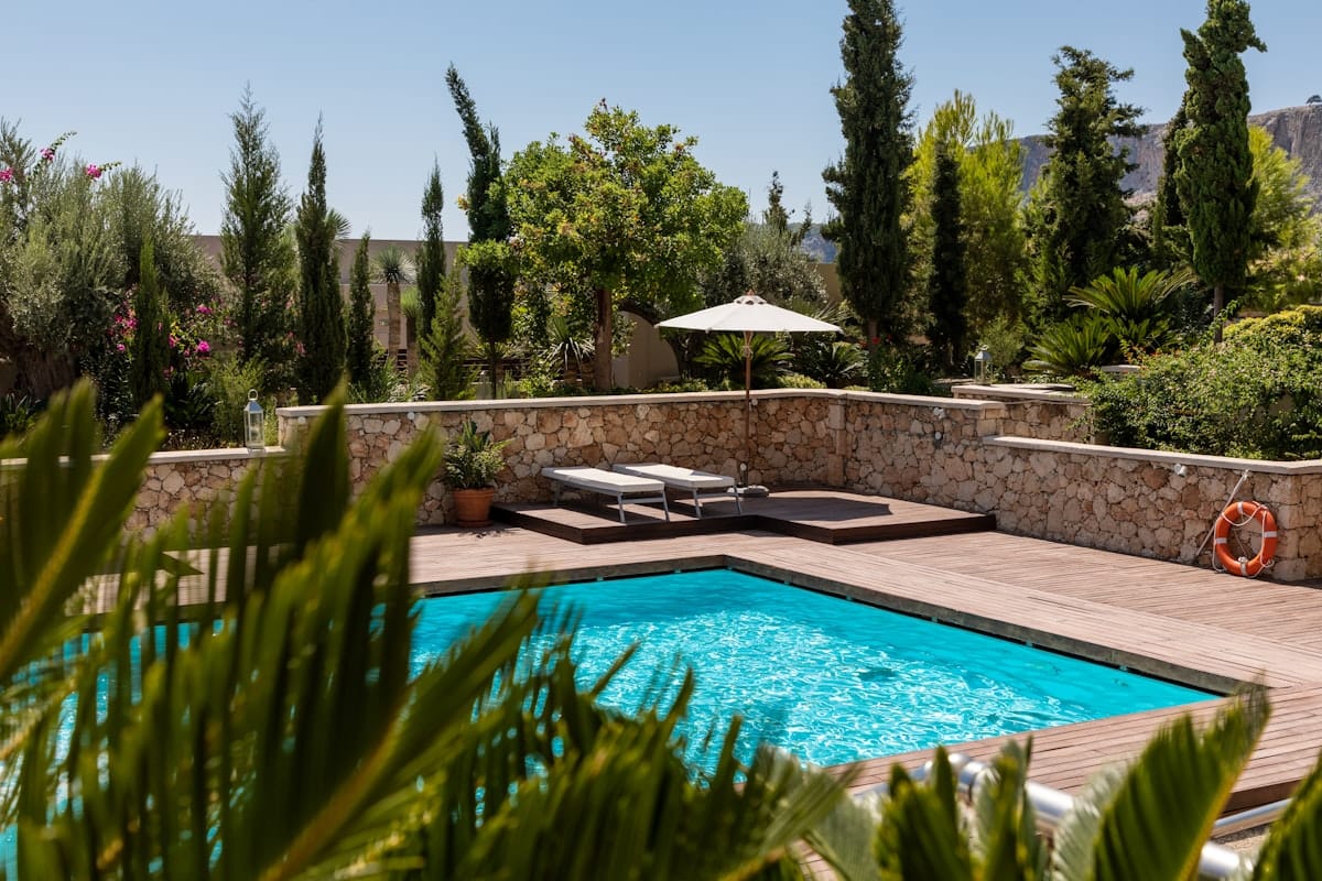 Before and after split image of a green swampy pool transformed into a sparkling blue oasis